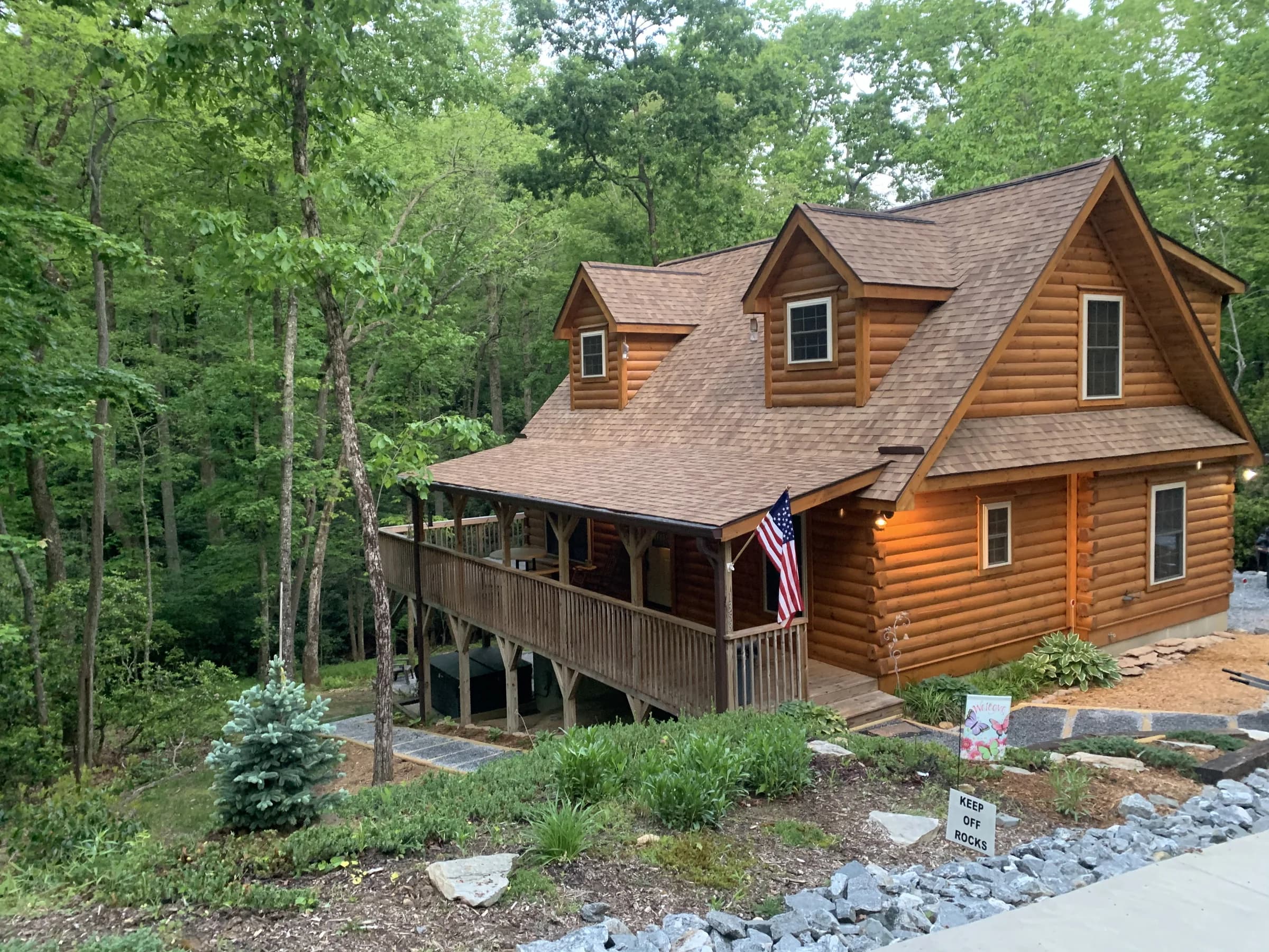 Whispering Trees Cabin surrounded by summer woods