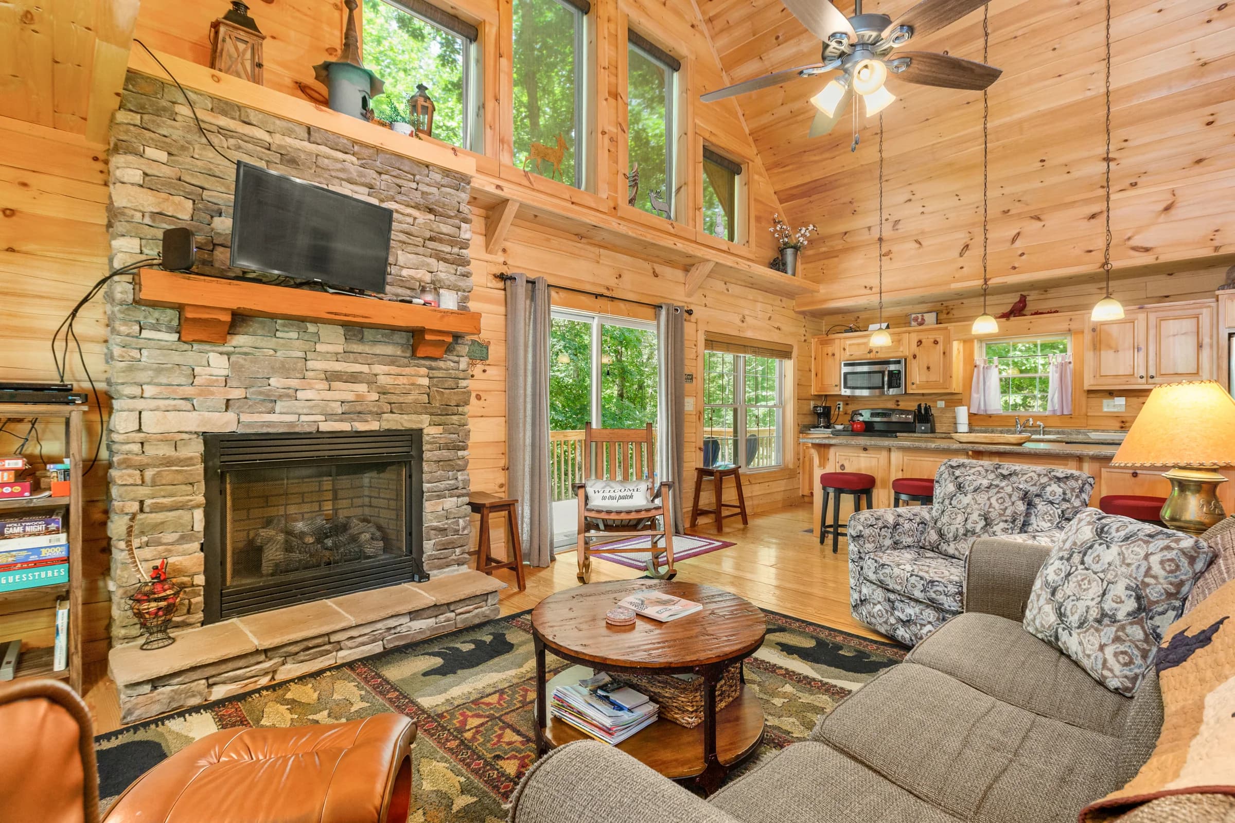 Whispering Trees Cabin fireplace, great room, and open kitchen