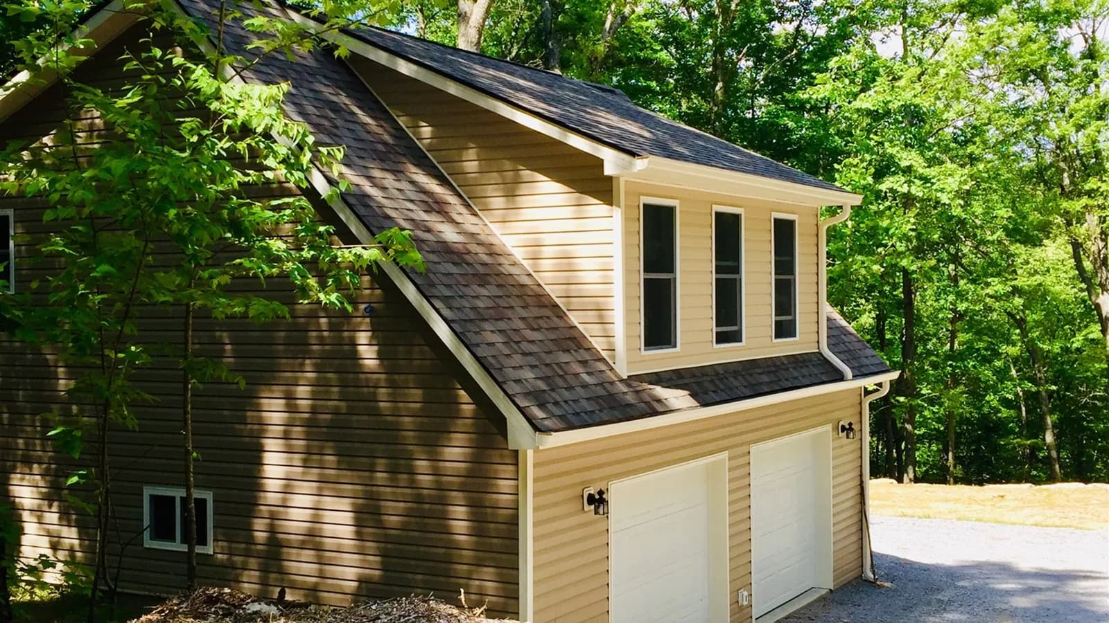 Whispering Trees Loft exterior above the locked garage with private stairs and parking