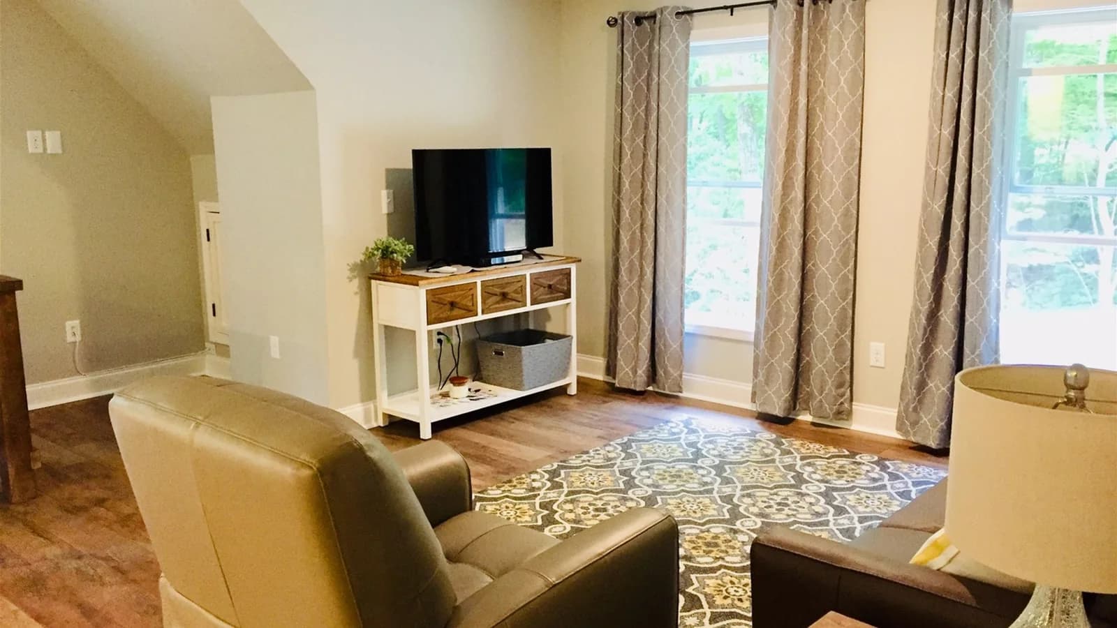 Whispering Trees Loft TV area beside the balcony doors